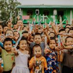 Kids show off their new toothbrushes at a shelter location