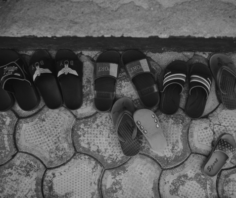 sets of small sandals on a cobblestone plaza