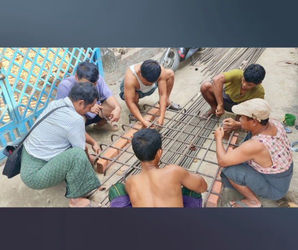 Men working, forming rebar for foundation construction