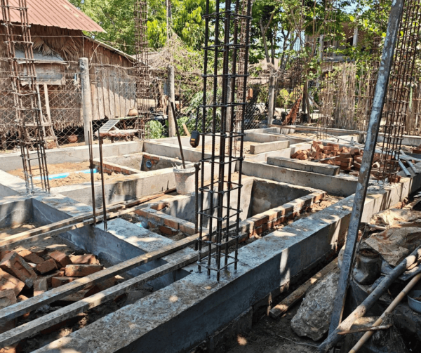 Construction foundation with rebar and concrete footings for new Myanmar shelter building