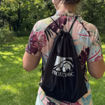 A branded Project Nic Run for Shelter swag bag backpack worn outdoors in natural light