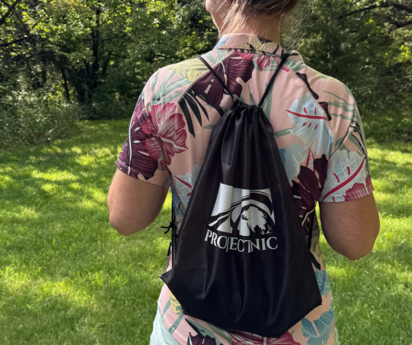A branded Project Nic Run for Shelter swag bag backpack worn outdoors in natural light
