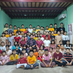 Group photo of children and caregivers at the completed first floor of the Project Nic Myanmar shelter