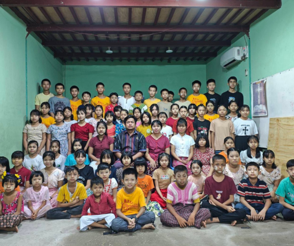 Group photo of children and caregivers at the completed first floor of the Project Nic Myanmar shelter