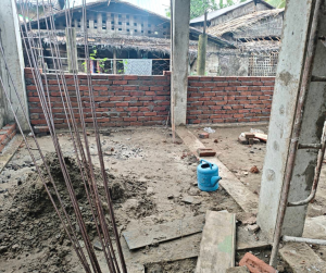 The second floor walls are going up — brick by brick, beam by beam.