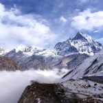 Nepali mountains under a cloudy sky with soft light breaking through
