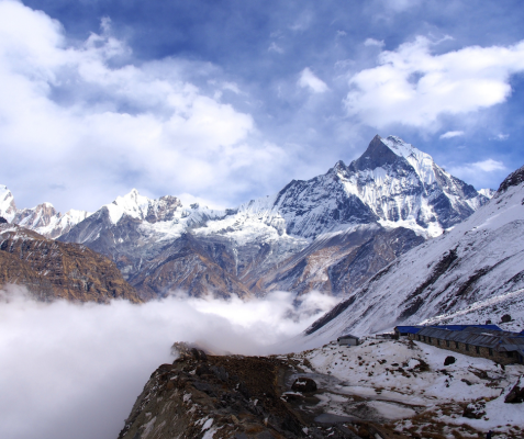 Nepali mountains under a cloudy sky with soft light breaking through