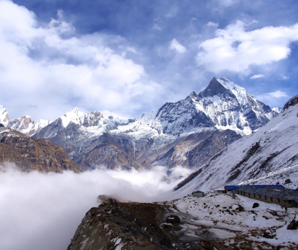 Nepali mountains under a cloudy sky with soft light breaking through